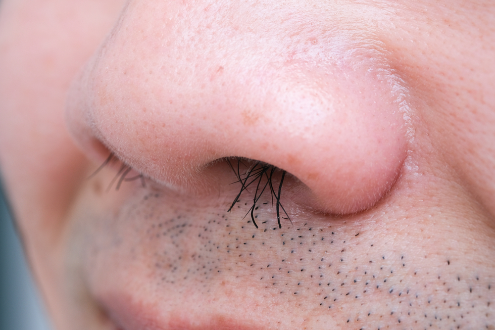 Young man's nose His nostrils are hairy. . Health and medical concepts